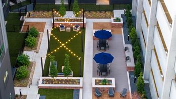 A rooftop garden with a table and chairs.